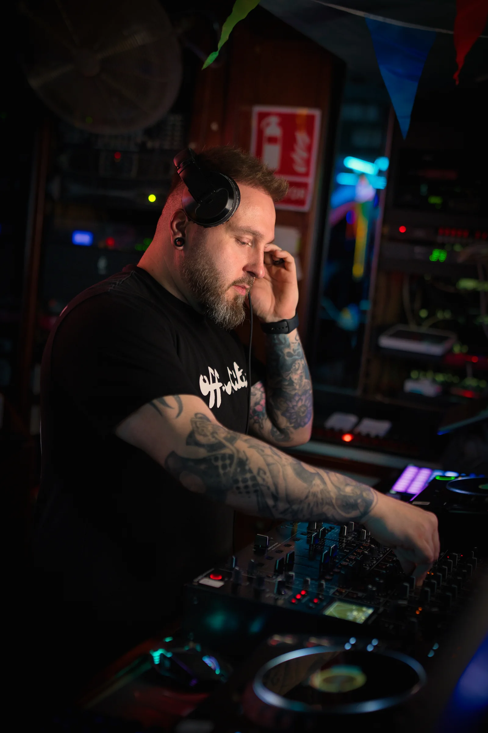 Ash Jenkins focused on the controls while performing in a club.