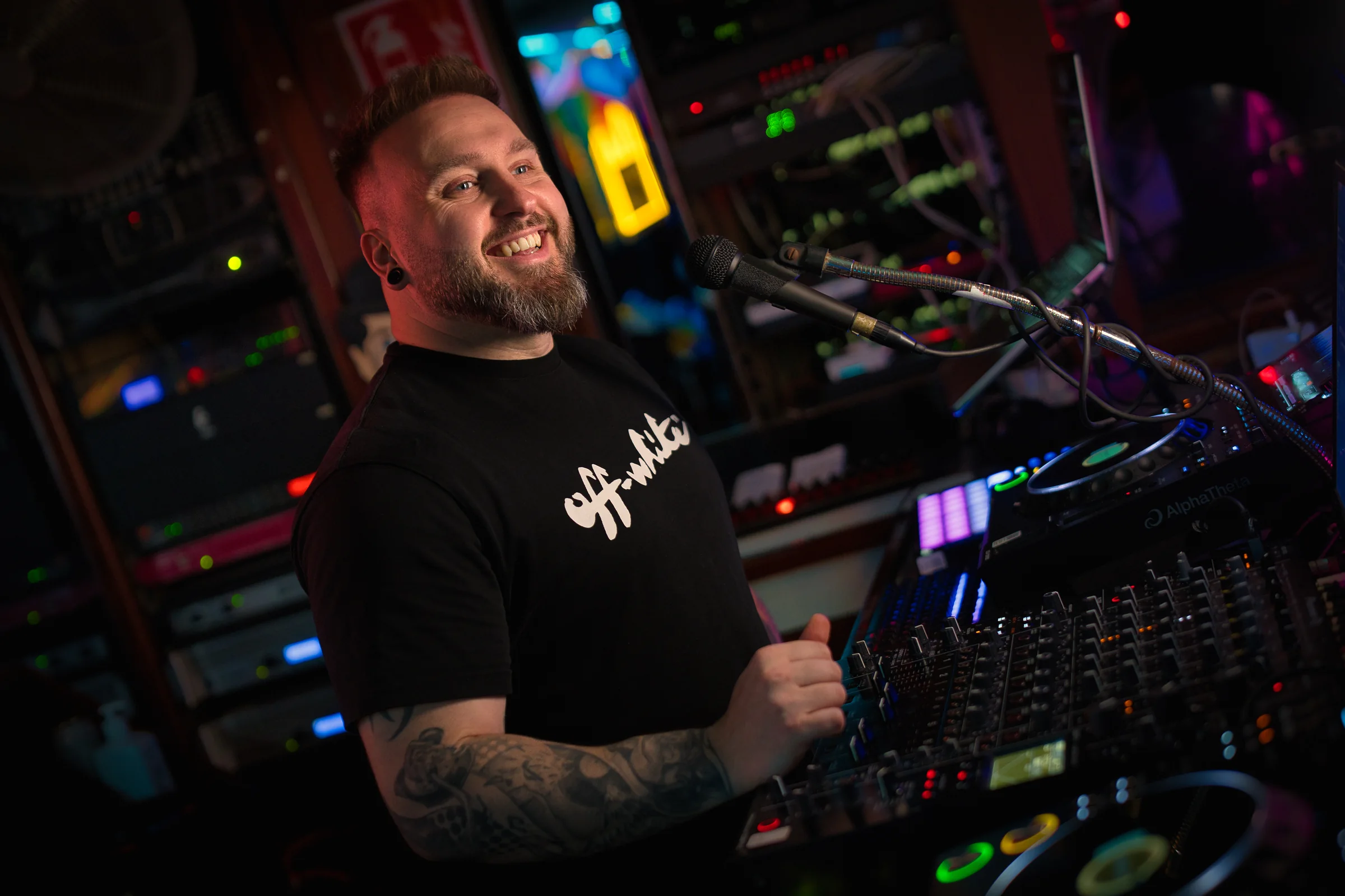 Ash Jenkins smiling during a live DJ performance.