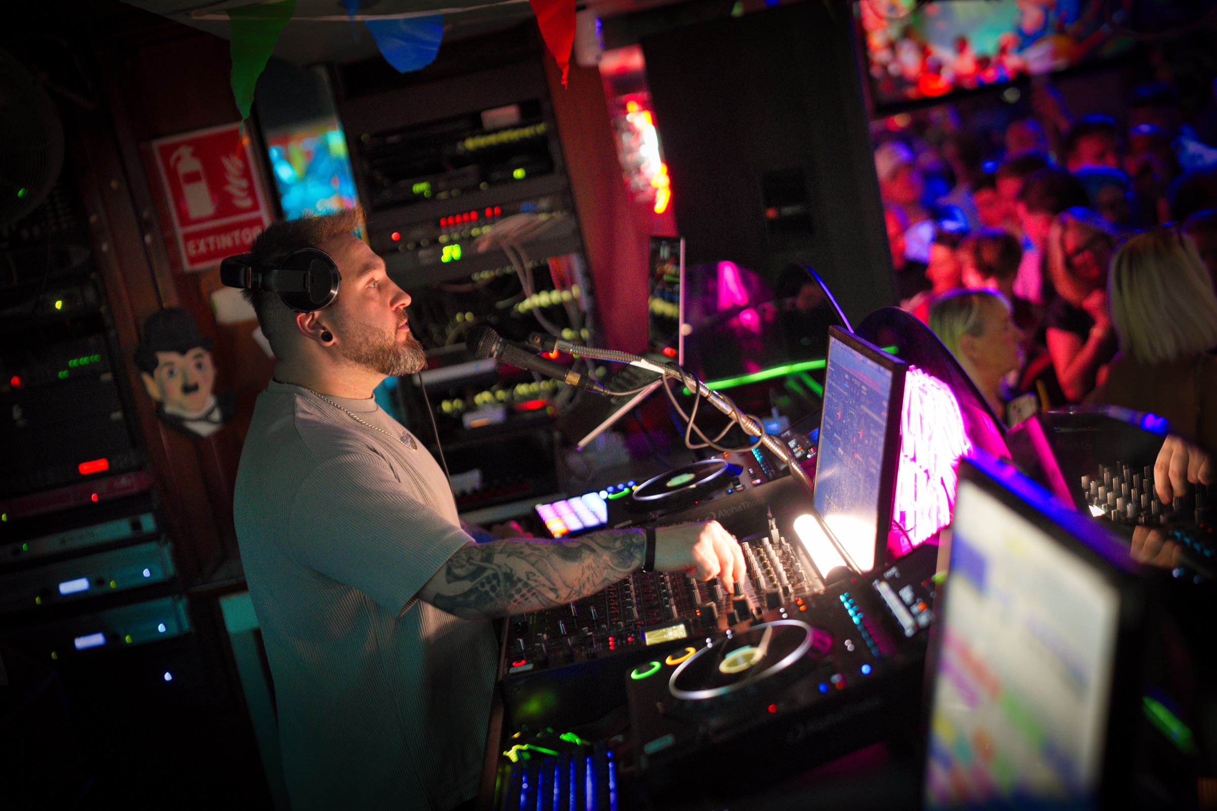 Ash Jenkins reading the room while performing from the DJ booth.