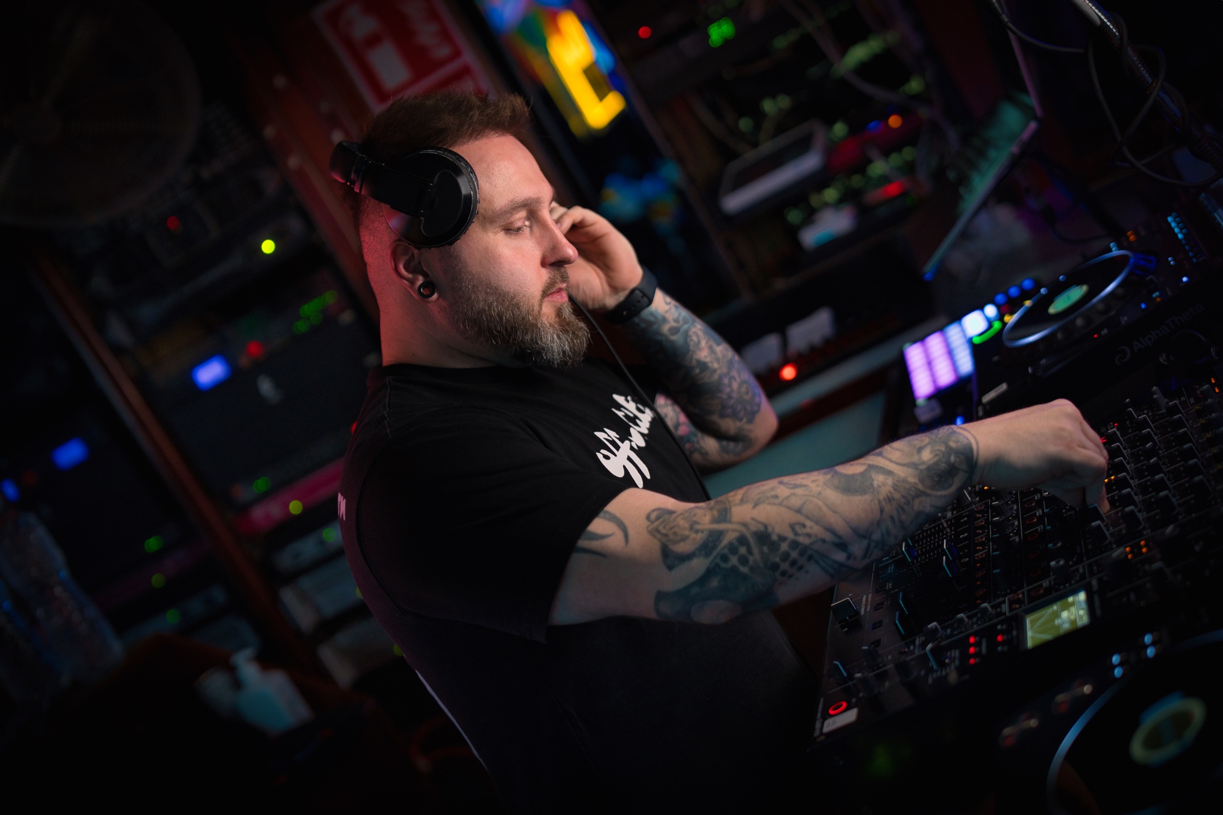 Ash Jenkins performing at a DJ mixer in a club